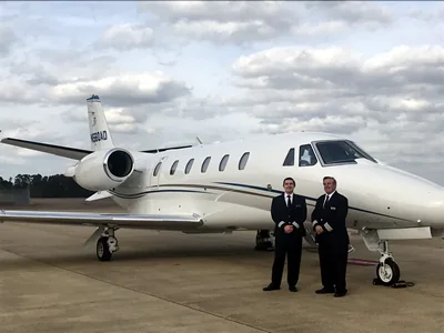 Flight crew standing in front of Citation Excel aircraft