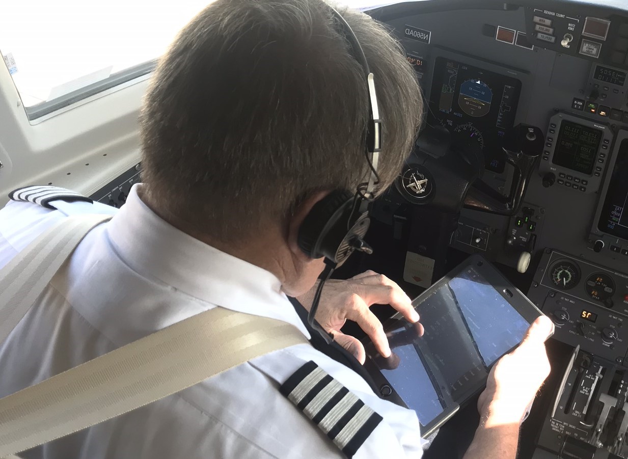 Captain using his iPad EFB in the cockpit of a Citation Excel