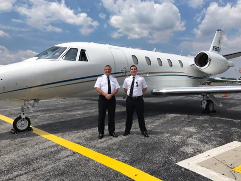 Air Direct flight crew standing in front of Citation Excel N560AD